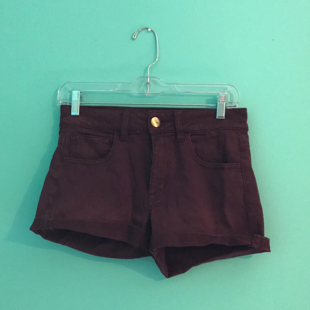 Maroon shorts, with gold button